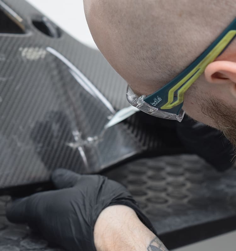 Stripping Back The Carbon Fibre Part To Allow For Repair