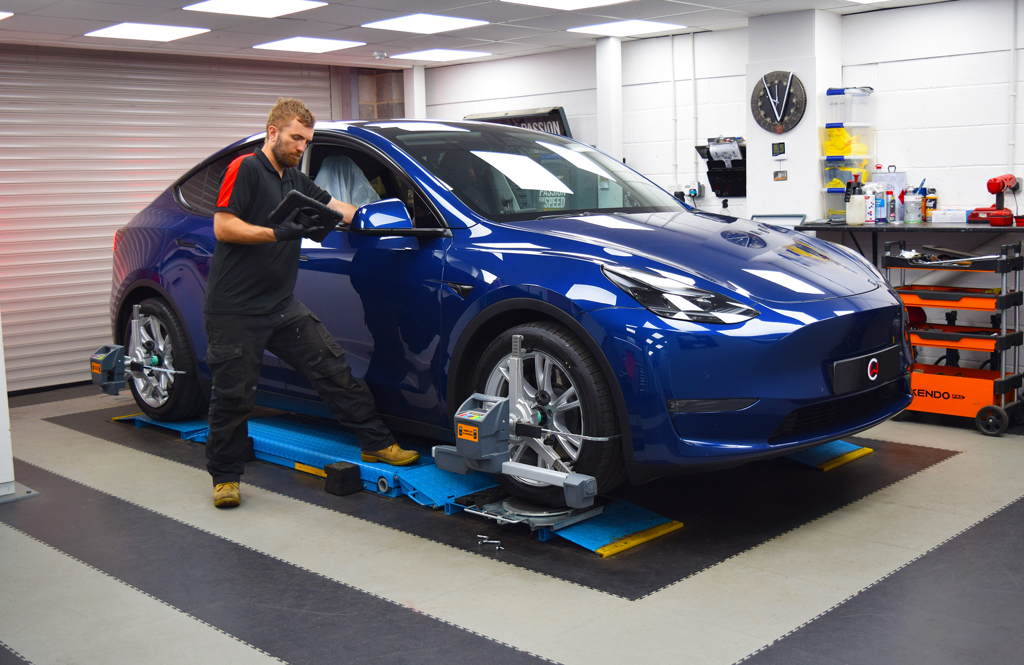 Carbonwurks technician fitting performance upgrades to Tesla Model Y